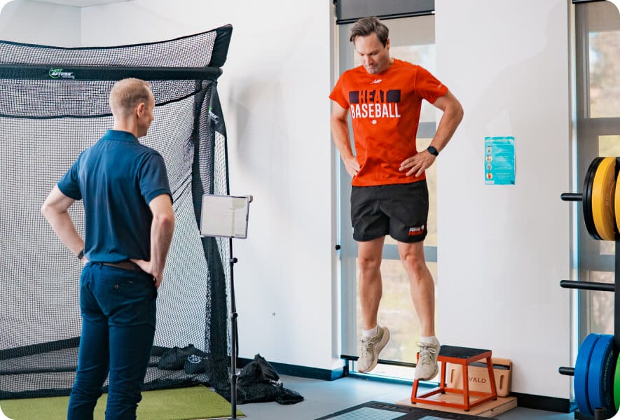 Athlete testing VALD strength equipment with physio